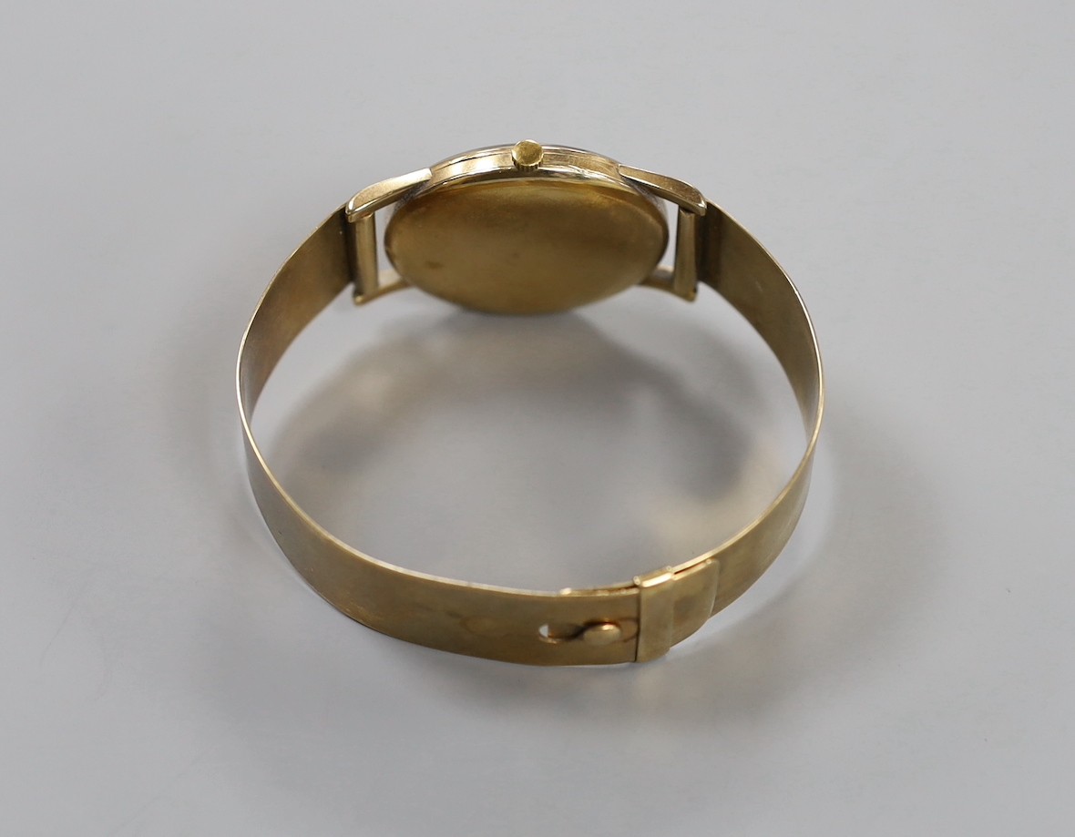 A gentleman's yellow metal Baume manual wind wrist watch, on a bracelet strap, gross weight 44.3 grams.